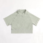 Green ribbed baby shirt on a white background