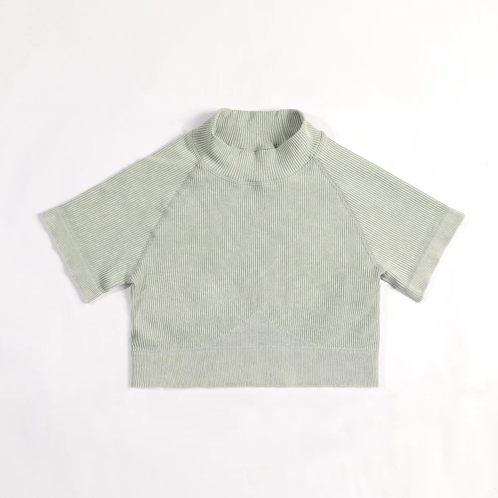 Green ribbed baby shirt on a white background