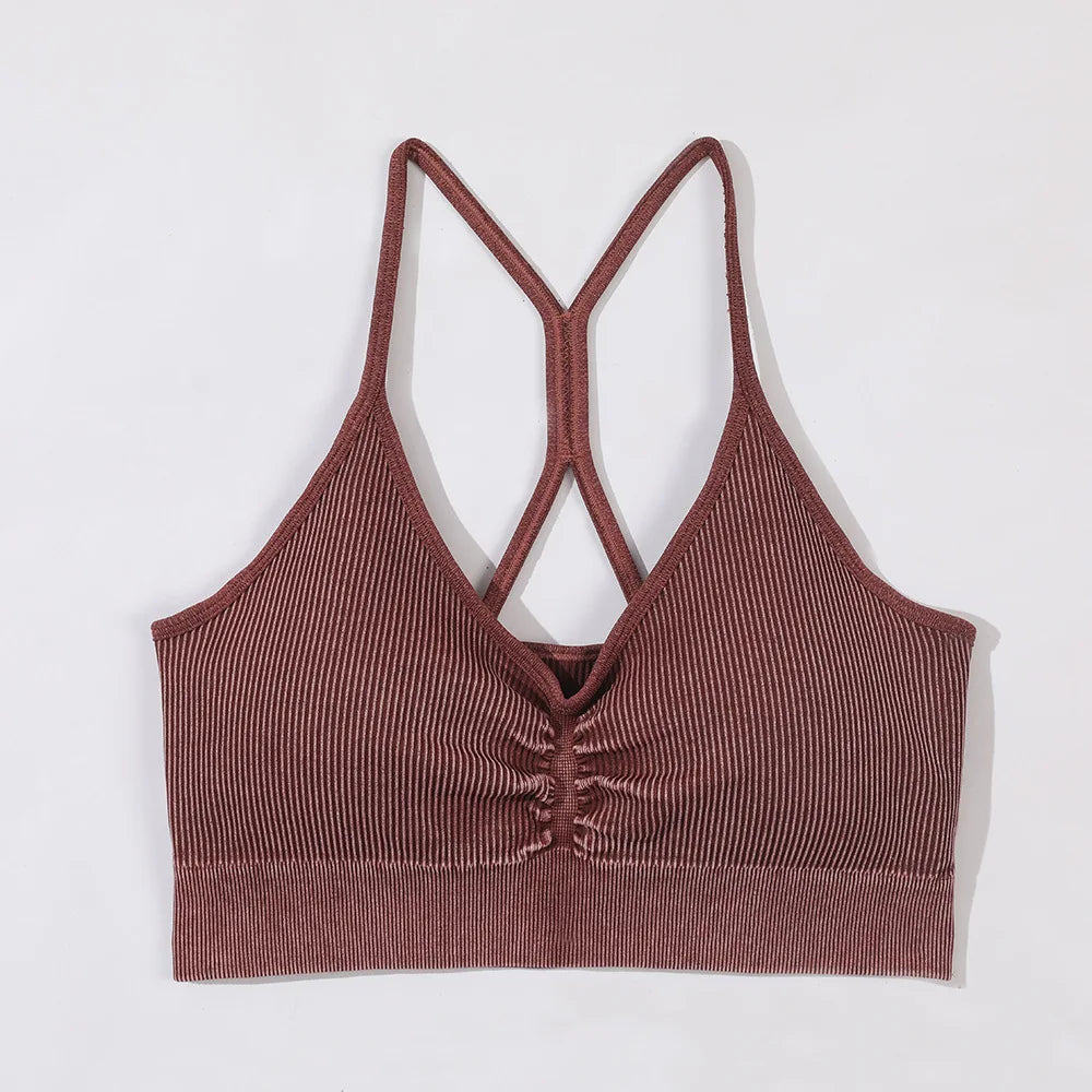 Brown ribbed crop top with criss-cross straps on a white background