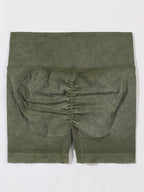Green ribbed knit shorts on a white background