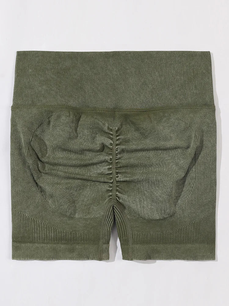 Green ribbed knit shorts on a white background