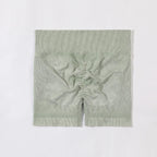 Green ribbed knit fabric on a white background