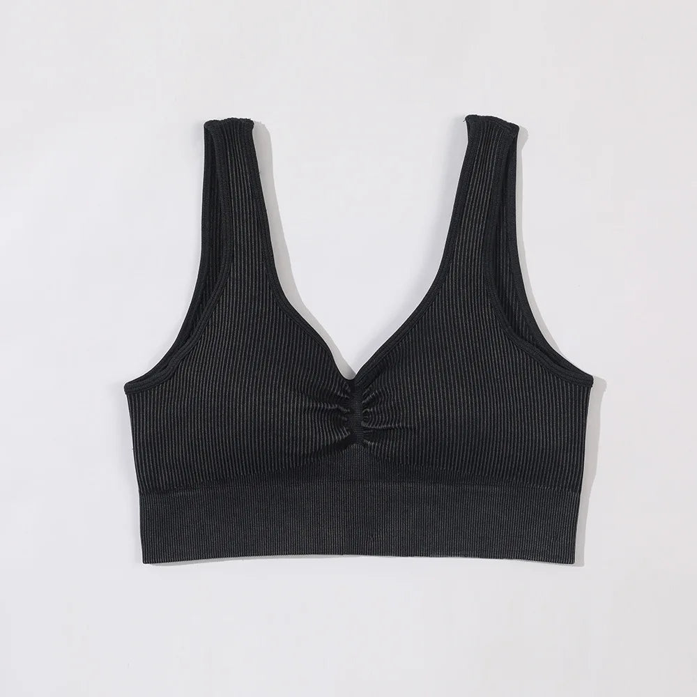 Black ribbed tank top on a light gray background