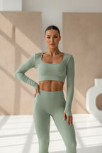 Green ribbed long-sleeve crop top on a white background