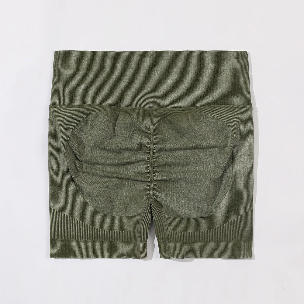 Green ribbed knit shorts on a white background