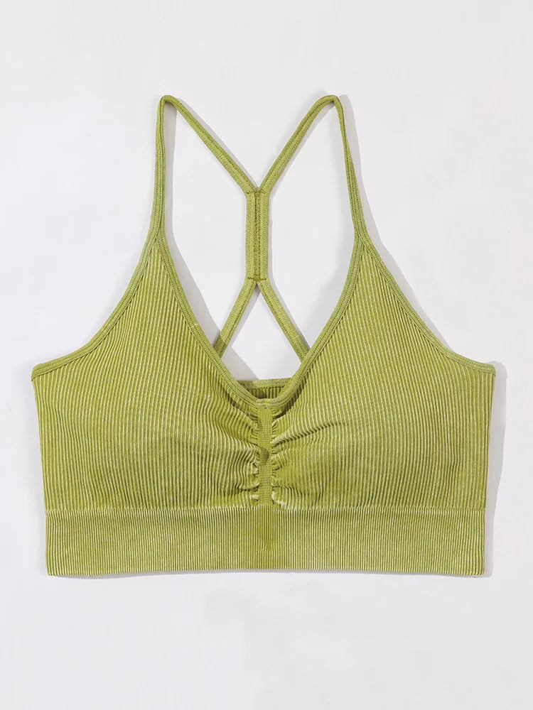 Green ribbed crop top with criss-cross straps on a white background