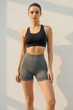 Person wearing gray athletic shorts on a light background
